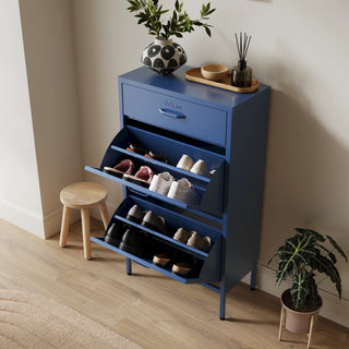 The Shoreditch shoe cabinet in navy blue with a top drawer, two lower shoe compartments and matching handles, styled in a hallway.